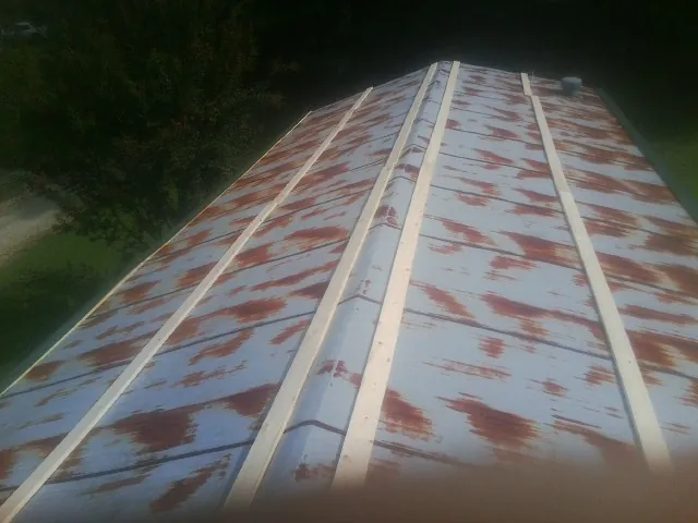 Rusted metal roof panels with new wood purlins before replacement — Storm Damage Roof Repair in Nevada City by Roofing Brothers